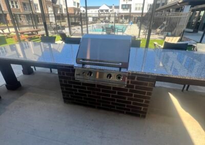 ADA-accessible outdoor kitchen counter and sink with open knee space at a multi-family community. Project: Majestic ADA Design. Builder: Majestic Outdoor Kitchens