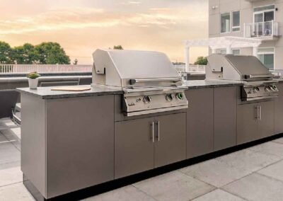 Revere, MA rooftop multi-family outdoor kitchen with Danver stainless steel cabinetry and two built-in grills. Project: Revere Rooftop Kitchen. Builder: Danver Outdoor Kitchens