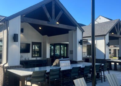 Covered grill pavilion with bar seating and accessible kitchen at a multi-family community. Project: Majestic ADA Design. Builder: Majestic Outdoor Kitchens