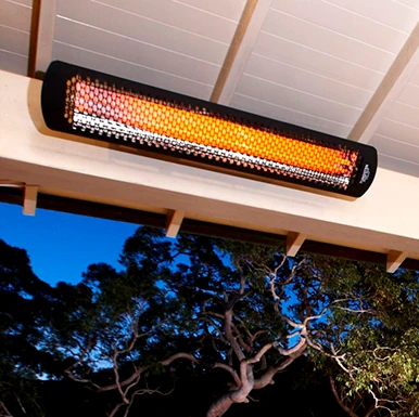 Bromic Tungsten electric infrared heater ceiling-mounted over an outdoor seating area
