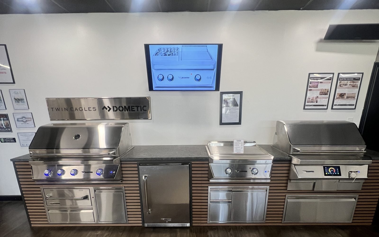 Twin Eagles outdoor kitchen on display in the Majestic Outdoor Kitchens showroom with grills, griddle, refrigerator, and drawers
